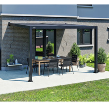 Pergola de terrasse noire avec table et chaises dans le jardin.