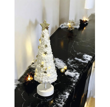 Sapin de Noël décoratif blanc en textile avec étoiles dorées et éclairage LED sur une surface en marbre noir.
