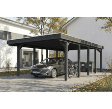 Abri de voiture avec voiture, vélo et poubelles devant une maison d'habitation