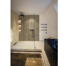 Salle de bains moderne avec douche à l'italienne, mur géométrique, paroi vitrée, baignoire noire et robinetterie noire.