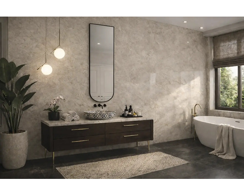 Salle de bain moderne avec grands carreaux muraux aspect marbre, meuble sous-vasque foncé, vasque à poser à motifs, miroir ovale et baignoire îlot.