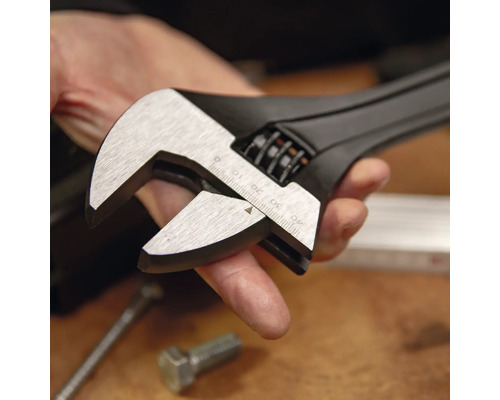 Verstellbarer Einmaulschlüssel aus schwarzem Metall mit silbernen Backen und Millimeterskala bis 40 Millimeter in einer Hand.