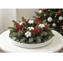 Festliches Weihnachtsgesteck mit Tannenzweigen, roten Rosen, Baumwollblüten und Tannenzapfen auf einem weissen Tablett.