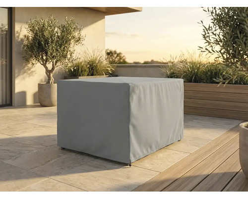 Housse de protection rectangulaire pour meubles de jardin sur une terrasse avec plantes en pots et sol en pierre à la lumière du jour.
