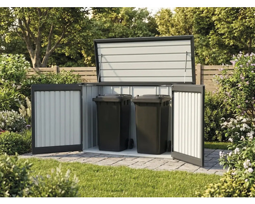 Abri pour poubelles en métal ouvert contenant deux poubelles noires sur une surface pavée dans un jardin.