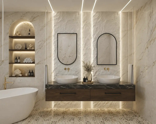 Salle de bains lumineuse avec double vasque en bois et marbre, deux vasques à poser, robinetterie murale dorée, miroirs arrondis et baignoire îlot.