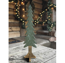 Grüner dekorativer Tannenbaum aus Holz auf einem Holzständer in rustikaler Umgebung mit Beleuchtung.