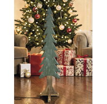 Dekorativer Holz-Tannenbaum auf Standfuß in weihnachtlicher Umgebung mit beleuchtetem Baum und Geschenken.