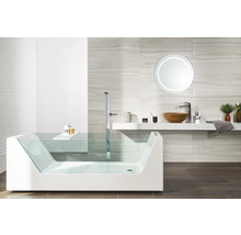 Salle de bains moderne avec baignoire en verre, robinetterie sur pied, vasque en bois et miroir rond rétroéclairé.