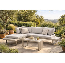 Salon de jardin moderne en métal avec coussins en tissu comprenant un canapé d angle et une table basse sur une terrasse pavée.