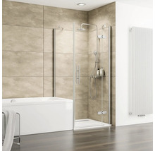 Salle de bain moderne avec cabine de douche en verre, baignoire blanche, carrelage mural beige aspect pierre et radiateur vertical blanc.