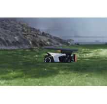 Abri de protection moderne pour robot tondeuse sur pelouse sous la pluie, design fonctionnel pour la protection contre les intempéries.