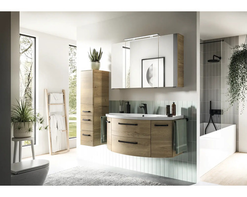 Ensemble de meubles de salle de bains moderne avec meuble sous-vasque arrondi aspect bois, lavabo, armoire de toilette éclairée et colonne.