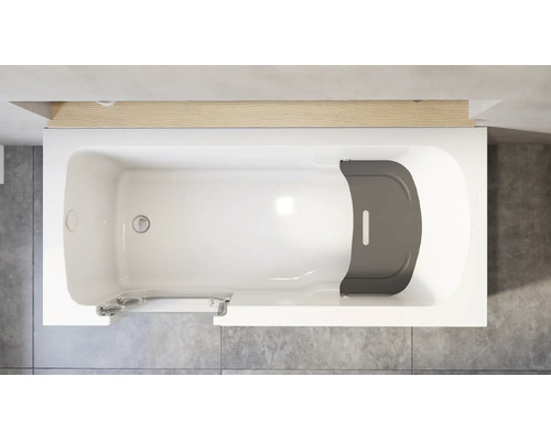Draufsicht auf eine weiße Badewanne mit integrierter Tür und grauem Sitz auf einem grauen Fliesenboden neben einer Holzleiste.