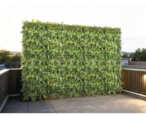 Künstliche Pflanzenwand als Sichtschutz auf einer Terrasse mit Fliesen und Geländer.