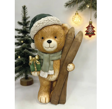 Weihnachtsdekoration Teddybär mit Skiern, Mütze, Schal und Geschenk.