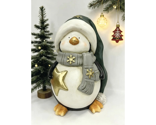 Weihnachtsfigur Pinguin mit Wintermütze, Schal und goldenem Stern.