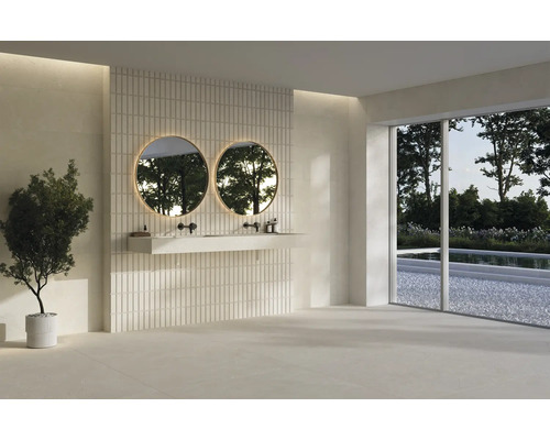 Salle de bains moderne avec plan vasque suspendu, deux miroirs ronds rétroéclairés, carrelage mural vertical et grandes dalles de sol. Lumineux.