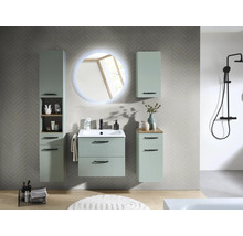 Salle de bains moderne avec meubles vert menthe, miroir LED rond, lavabo, colonne et système de douche noir sur carrelage gris.