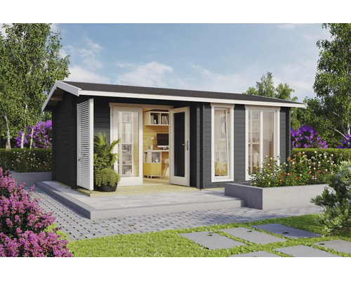 Abri de jardin moderne en bois anthracite avec fenêtres et portes blanches, aménagé en bureau de jardin lumineux sur une terrasse en pierre.