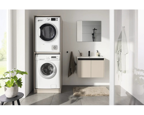 Buanderie moderne avec meuble pour lave-linge et sèche-linge superposés, meuble sous-vasque et miroir.