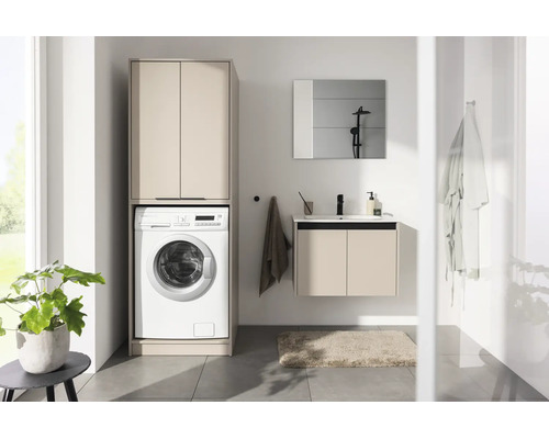 Armoire pour lave-linge moderne avec lave-linge intégré et meuble sous vasque assorti dans une salle de bain lumineuse.