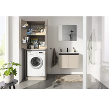 Salle de bain moderne avec meuble pour lave-linge, meuble sous-vasque, miroir et carrelage.