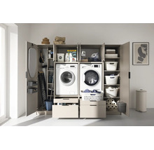 Armoire de buanderie avec compartiments pour lave-linge et sèche-linge, tiroirs, étagères pour paniers à linge et rangement intégré.