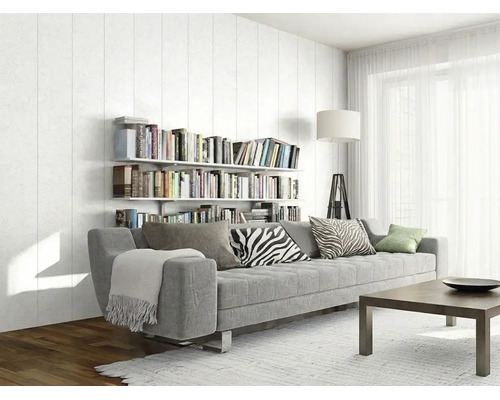 Salon moderne et lumineux avec un grand canapé gris, des étagères murales remplies de livres, une table basse en bois et de grandes fenêtres.