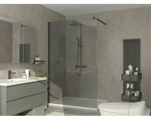 Salle de bains moderne avec douche à l'italienne en verre, meuble vasque gris, lavabo blanc, radiateur noir et carrelage gris.