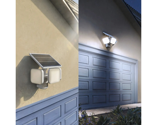 Solar-LED-Aussenstrahler mit Bewegungsmelder und zwei verstellbaren Köpfen, montiert an einer Hauswand über einem Garagentor.