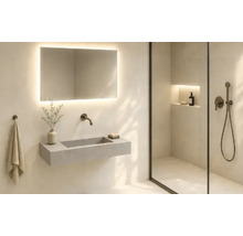 Salle de bains moderne avec un lavabo mural, un miroir éclairé et une douche en verre avec niche murale.