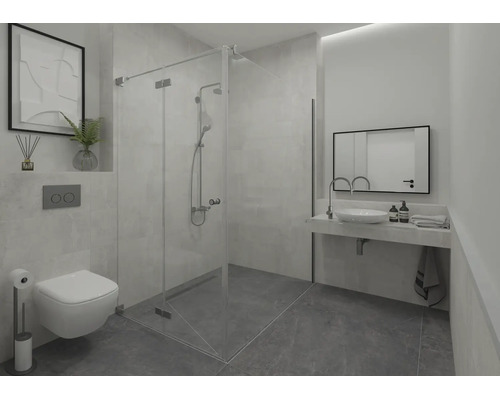 Salle de bain moderne avec cabine de douche en verre, WC suspendu, lavabo avec miroir et carrelage de sol foncé.