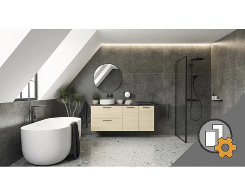 Modernes Badezimmer unter Dachschräge mit freistehender Badewanne, hängendem Waschtisch, rundem Spiegel, grauen Fliesen und Terrazzo-Boden.