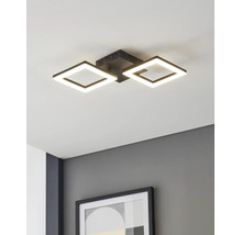 Plafonnier LED moderne avec deux cadres noirs carrés, monté sur un plafond blanc au-dessus d'un mur gris avec un cadre photo.