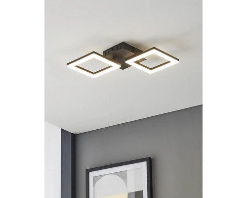 Plafonnier LED moderne avec deux cadres noirs carrés, monté sur un plafond blanc au-dessus d'un mur gris avec un cadre photo.