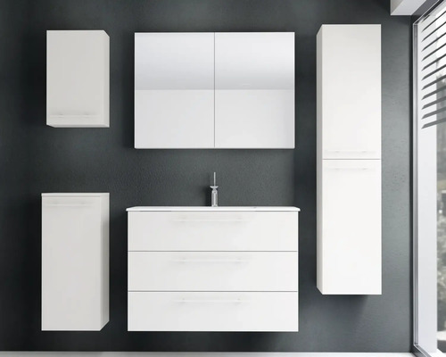 Ensemble de meubles de salle de bains blancs comprenant un sous-lavabo avec trois tiroirs, un lavabo, une armoire de toilette et des colonnes.