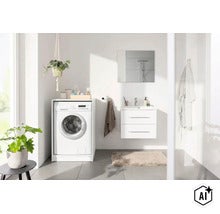 Salle de bain moderne et lumineuse avec meuble pour lave-linge blanc, meuble sous-vasque suspendu et miroir. (Image AI modified or generated)