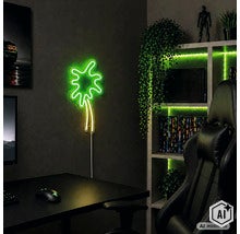 LED Neonwandleuchte in Palmenform an einer dunklen Wand in einem Gaming Zimmer mit Schreibtisch und Gaming Stuhl. (Image AI modified or generated)