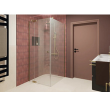 Douche d angle moderne avec parois en verre et ferrures aspect or dans une salle de bain carrelée avec lavabo et porte.
