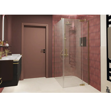 Douche d angle moderne en verre véritable avec ferrures dans une salle de bain avec carreaux carrés et lavabo avec robinetterie dorée.