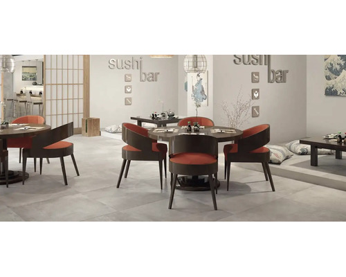 Intérieur de restaurant de sushi moderne avec tables rondes, chaises courbes et sol carrelé dans un design d'inspiration japonaise.