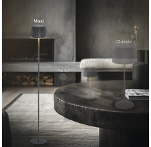 Quatre tailles différentes de lampes de table et lampadaires à LED avec abat-jour plissé dans un salon moderne