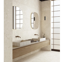 Salle de bains moderne avec deux vasques, meuble sous vasque suspendu en bois, miroirs ovales et carrelage aspect pierre naturelle.