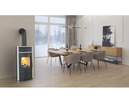 Poêle moderne avec un feu allumé dans un salon devant une fenêtre donnant sur un paysage hivernal enneigé.