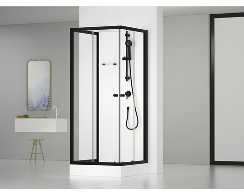 Douche d''angle avec cadre noir et robinetterie de douche dans une salle de bain moderne.