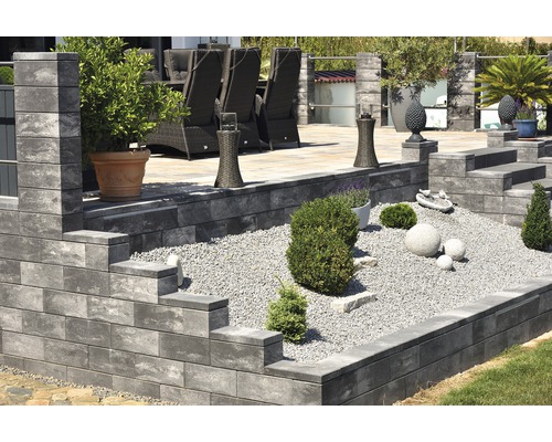 Gestufter Garten mit Pflastersteinen, Kies und Dekoration