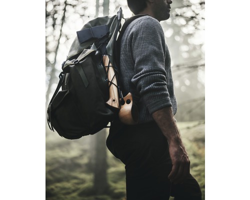 Mann mit Rucksack und Axt im Wald