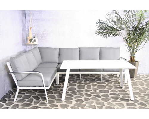 Salon de jardin avec canapé d''angle, table et coussins gris sur une terrasse