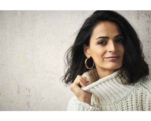 Porträt einer Frau mit Strickpullover und Ohrringen